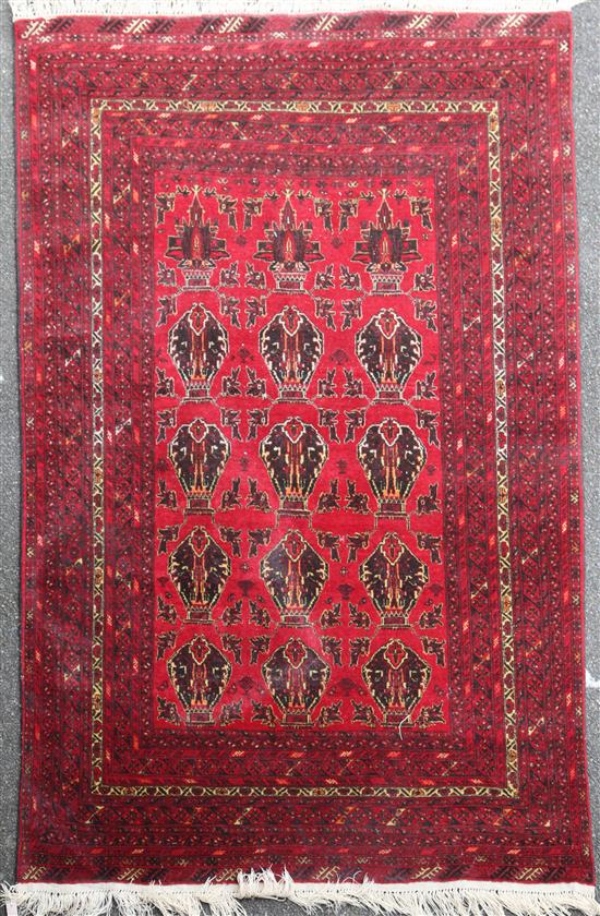An Afghan carpet, 9ft 4in by 6ft 6in.